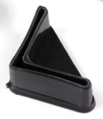 A black, triangular-shaped rubber doorstop with a slanted design, placed upright on a white surface.