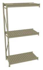 Three-tiered metal storage shelf with vertical support beams on the left. Each shelf has slatted surfaces and the structure appears robust and industrial. The shelves are evenly spaced and have a utilitarian design.