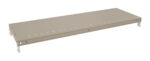 A beige metal shelf with a flat, rectangular surface and small holes aligned along the edges. The shelf appears sturdy and is designed for use in shelving units. It has metal brackets at each end for attachment.