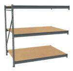 Three-tier industrial metal shelving unit with light brown wooden shelves. The frame is dark gray, with a cross-brace for stability on the left side. The shelves are evenly spaced and designed for heavy-duty storage. White background.