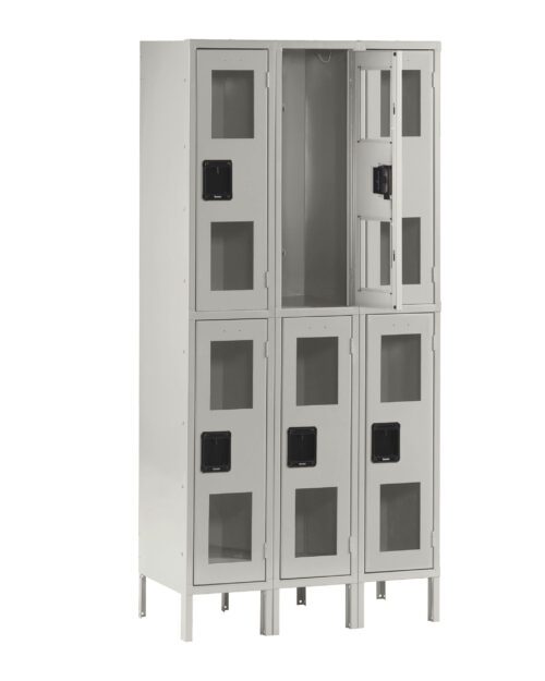 rs4t1n85ls3krsmzs3ne.jpg A tall, gray metal locker with six compartments arranged in two columns. Each compartment has a transparent window and a black handle. One of the upper compartments is open, showing the empty interior.