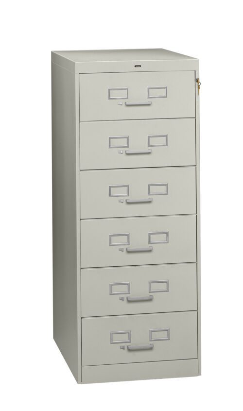 Tall, light gray metal filing cabinet with five drawers and label holders on each drawer. The cabinet has a lock on the right side near the top.