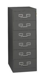 A tall, gray filing cabinet with six drawers. Each drawer has a silver handle and a label holder. The cabinet has a lock at the top right corner, providing secure storage, and stands on flat legs.