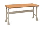 A sturdy workbench with a wooden tabletop and metallic legs. The legs have adjustable height settings, and there is a support beam connecting the legs for added stability. The design is minimal and functional, suitable for workshop use.