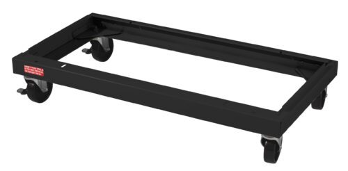 A black metal dolly with four swivel casters, designed to transport heavy objects. It has a rectangular frame and a small red sticker on one side with white text.