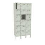 A beige metal locker unit with 18 individual compartments arranged in three columns and six rows. Each compartment has a ventilation slot and a lock mechanism. One door is slightly open, revealing a dark interior.