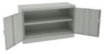 A gray metal cabinet with two doors wide open, revealing empty shelves inside. The cabinet has a simple, utilitarian design and a rectangular shape.