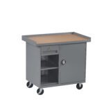 A gray metal rolling cart with four wheels. It features a flat tabletop surface, a lockable door on the right with a handle, and three open shelves on the left for storage.