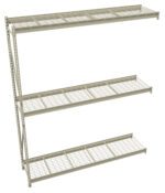 A metal wire shelving unit with three tiers. Each shelf is supported by a vertical frame on one side, creating open space for storage. The shelves are made of a grid pattern, and the entire unit is gray in color.
