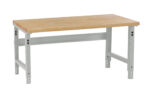 A sturdy workbench with a wooden tabletop and gray metal legs. The bench has adjustable height slots and a simple, functional design, suitable for various workshop tasks.