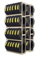 A large, metal shelving unit filled with multiple rows of black tires, each with a yellow label. The shelves are organized in three vertical columns and four horizontal rows. The tires are neatly stacked on the shelves.
