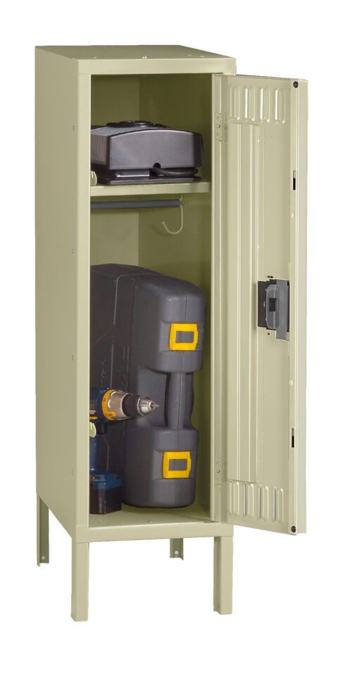 A beige metal storage locker stands open, revealing two shelves. The top shelf holds a small black suitcase, while the bottom shelf contains a drill inside a black and yellow toolbox and a small can.