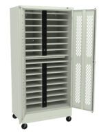 A tall, white metal cabinet on wheels with perforated doors stands open. Inside, multiple horizontal shelves are visible, designed to hold laptops or similar devices. Two vertical power strips are mounted in the middle of the cabinet.