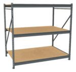A large, freestanding metal shelving unit with three wooden shelves. The frame is dark gray, and the shelves are light brown. The unit has support beams at the back and sides.