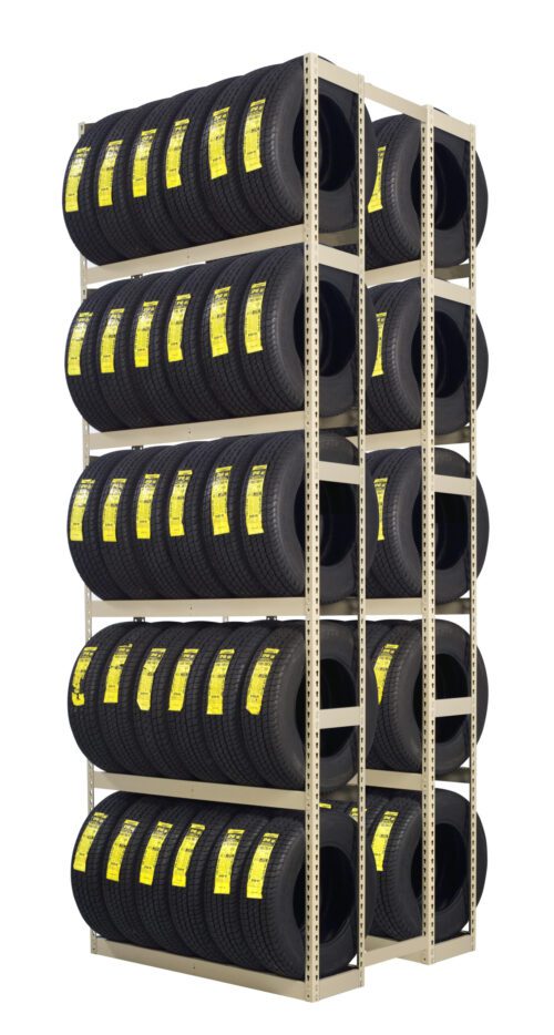 A tall, multi-tiered metal rack holds numerous black tires. Each tire has a yellow label affixed to its tread. The rack is organized neatly in vertical columns and horizontal rows, displaying the tires in a warehouse or storage setting.
