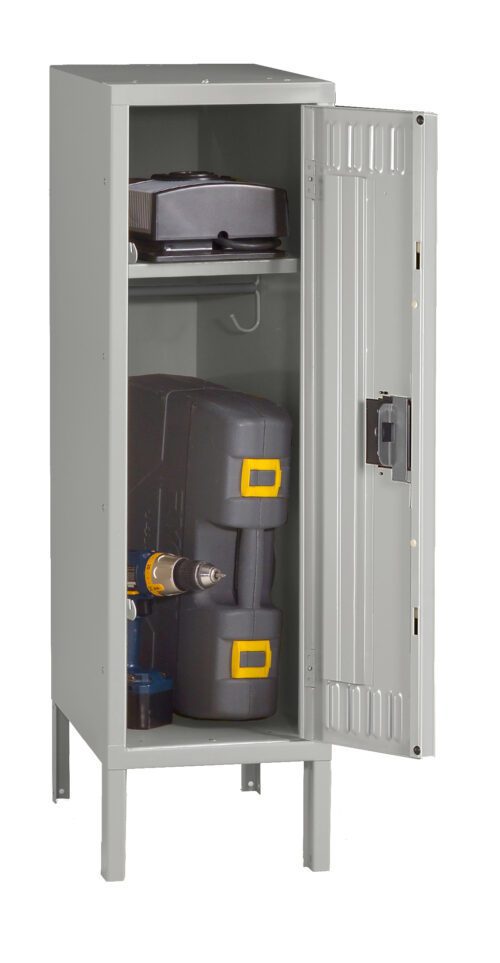 A gray metal storage cabinet with one door open. Inside, there are two shelves: the top shelf holds a black toolbox and the bottom shelf contains a black and yellow equipment case and a cordless drill.