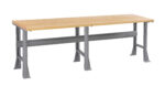 A long workbench with a wooden top and sturdy gray metal legs, featuring a crossbar for support. The design is simple and functional, suitable for various workspace needs.