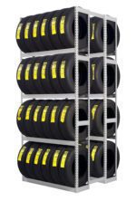 A metal rack filled with multiple rows of black car tires, each labeled with a yellow sticker, organized in three levels. The tires are neatly arranged to maximize storage space.