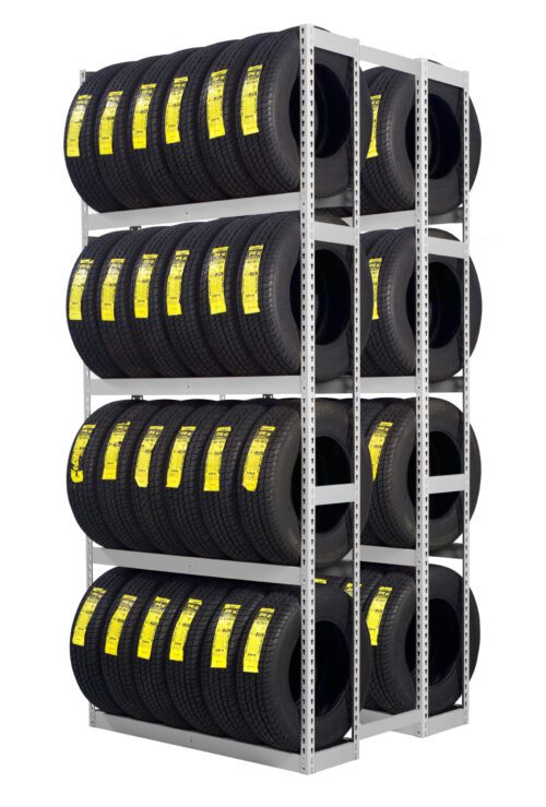 A metal rack filled with multiple rows of black car tires, each labeled with a yellow sticker, organized in three levels. The tires are neatly arranged to maximize storage space.