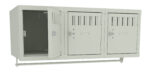 A set of three light gray metal lockers mounted on a frame, with one locker door open, showing the empty interior. The other two lockers are closed, each featuring ventilation slots and keyholes.