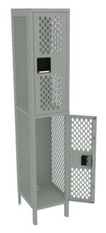 A tall, two-tiered metal locker with a perforated diamond pattern. The upper compartment is closed, while the lower door is open, displaying an empty interior. The locker is painted in a light gray color and stands on four short legs.