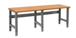 A long wooden workbench with a light brown top and sturdy gray metal legs, featuring a simple and clean design. It is suitable for workshops or garages.