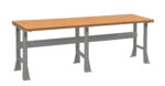 A sturdy workbench with a brown wooden top and gray metal legs. The bench is rectangular and positioned against a white background.