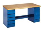 A sturdy blue metal desk with a wooden top. It features five drawers on the left side and a cabinet on the right. The desk has a minimalist design and is suitable for a workspace or workshop.