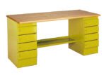 A wooden desk with a light wood top and olive green sides. It features two sets of drawers, five on each side, with metal handles and a connecting shelf underneath. The design is simple and functional.