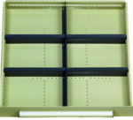Empty beige retail display shelf with four black horizontal bars and two vertical dividers. There are no products on the shelves. The background is plain.