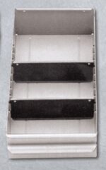 A three-tiered, wall-mounted metal shelf with two black dividers separating the compartments. The shelves are grey, and the unit appears industrial, likely used for organizing tools or materials. Its set against a plain background.