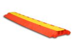 The TCT 2 - Channel Heavy Duty Cable Protector, featuring a red and yellow design with a textured surface, is perfect for organizing cables. Its open yellow lid reveals two spacious channels for effective cable management and protection.