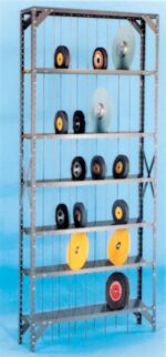 A metal shelving unit with multiple tiers, displaying various circular grinding wheels in different sizes and colors. The background is a solid light blue.