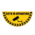 A yellow, semi-circular sign with a black CCTV camera silhouette and CCTV IN OPERATION above it features the design MH-USA Floor Graphic Markers - Half Circle - W.29.53 in., accented by black chevron patterns along the curved edge.