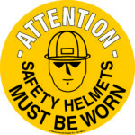 A yellow, black-outlined MH-USA Floor Graphic Marker (16.93-inch diameter) features a person in a helmet and sunglasses illustration with text: Attention - Safety Helmets Must Be Worn.