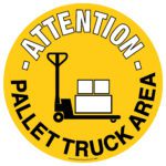 A yellow circular sign with a 16.93 in. diameter shows a black outline of a pallet truck with boxes and bold text ATTENTION - PALLET TRUCK AREA, serving as an effective MH-USA Floor Graphic Marker to alert warehouse staff.