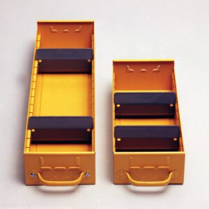 Two yellow modular storage boxes with black adjustable dividers are side by side. Each box has a handle at the front. The surface is a neutral off-white color.