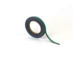 A roll of MH-USA Magnetic Easy-Wipe Strip in vibrant green, measuring H.0.39 in. x W3.94 in., stands upright with a small length unrolled against a plain white background, showcasing its sleek profile and readiness for your organizing needs.