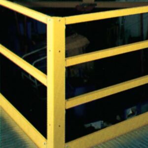 A yellow metal safety railing on a platform surrounds a dark area below, much like an efficient workspace organization design. The railing, with vertical and horizontal bars secured by bolts, stands firmly on the textured metal surface.