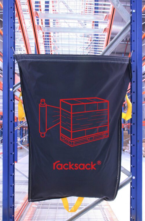 RSB1PSNT.jpg A black sack labeled MH-USA Racksack Symbol Only - Shrink Wrap featuring a red shrink wrap icon on a pallet hangs between metal shelves in a warehouse.