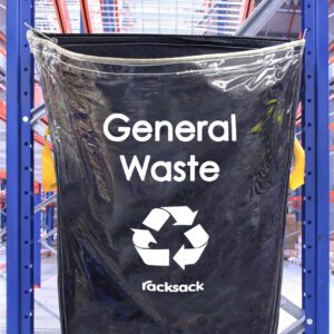 A clear MH-USA Racksack labeled General Waste with a recycling symbol hangs on a blue industrial racking system, set against metal shelves in a busy warehouse, showcasing the quality of MH-USA Racksack solutions for waste management.