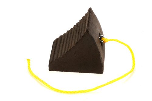 The TCT Contour Heavy-Duty Wheel Chock, ribbed one-sided in black (8.5x8x7.25), features a grooved surface and has a bright yellow rope threaded through a metal eyelet for easy handling.