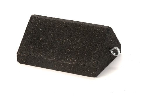 A rectangular block with angled corners and an eye bolt resembles the TCT Triangle Heavy-Duty Wheel Chock. Its smooth, double-sided, black, measures 10x7.75x5, and rests against a white backdrop, ready for reliable performance.