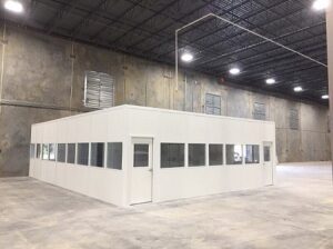 Prefabricated modular building installed inside an industrial facility