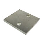 Metal plate with a rectangular shape and two circular holes near the center, positioned diagonally against a plain white background. The surface appears slightly textured.