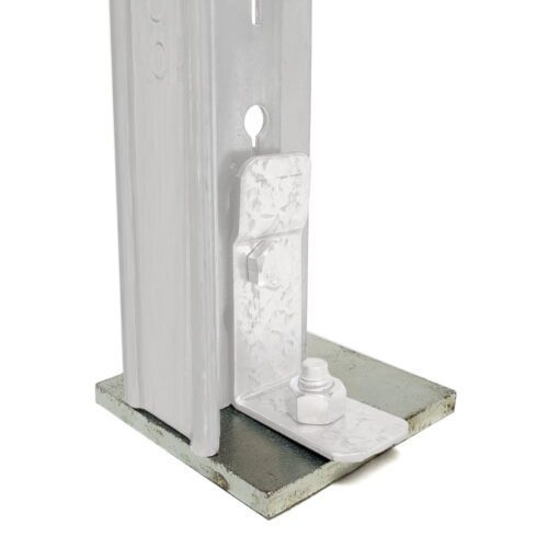 Close-up of a metallic bolt and bracket assembly attached to a pole. The structure is mounted on a flat, square base. The metal components have a silver finish, and the setup appears industrial or structural, suitable for construction purposes.