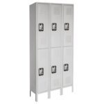 A row of six gray metal lockers, arranged in two columns with three lockers each. Each locker has a vented door and a handle. The lockers are standing on legs, elevating them slightly off the ground.