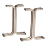 Two metal table legs with an industrial design, featuring a sleek, u-shaped curvature and a metallic finish. They are positioned parallel to each other on a white background.
