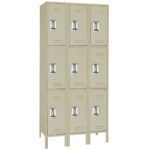 A beige metal locker unit with nine compartments, arranged in three rows and three columns. Each locker has a vertical ventilation slot and a metal handle. The unit stands on four legs.