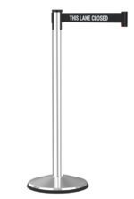 A metal stanchion with a black retractable belt displaying the text This Lane Closed. The base is round and sturdy, supporting the sleek, vertical pole.